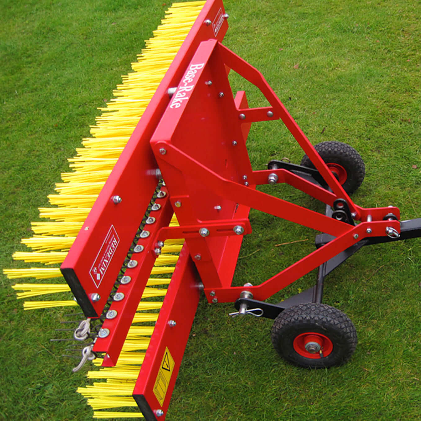 Base rake with tines and brush